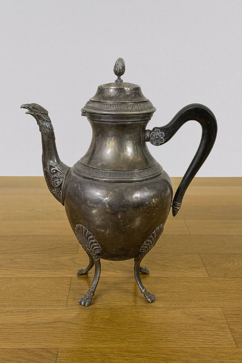 Empire style silver-plated verseuse, resting on three sculpted feet.