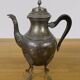 Empire style silver-plated verseuse, resting on three sculpted feet.