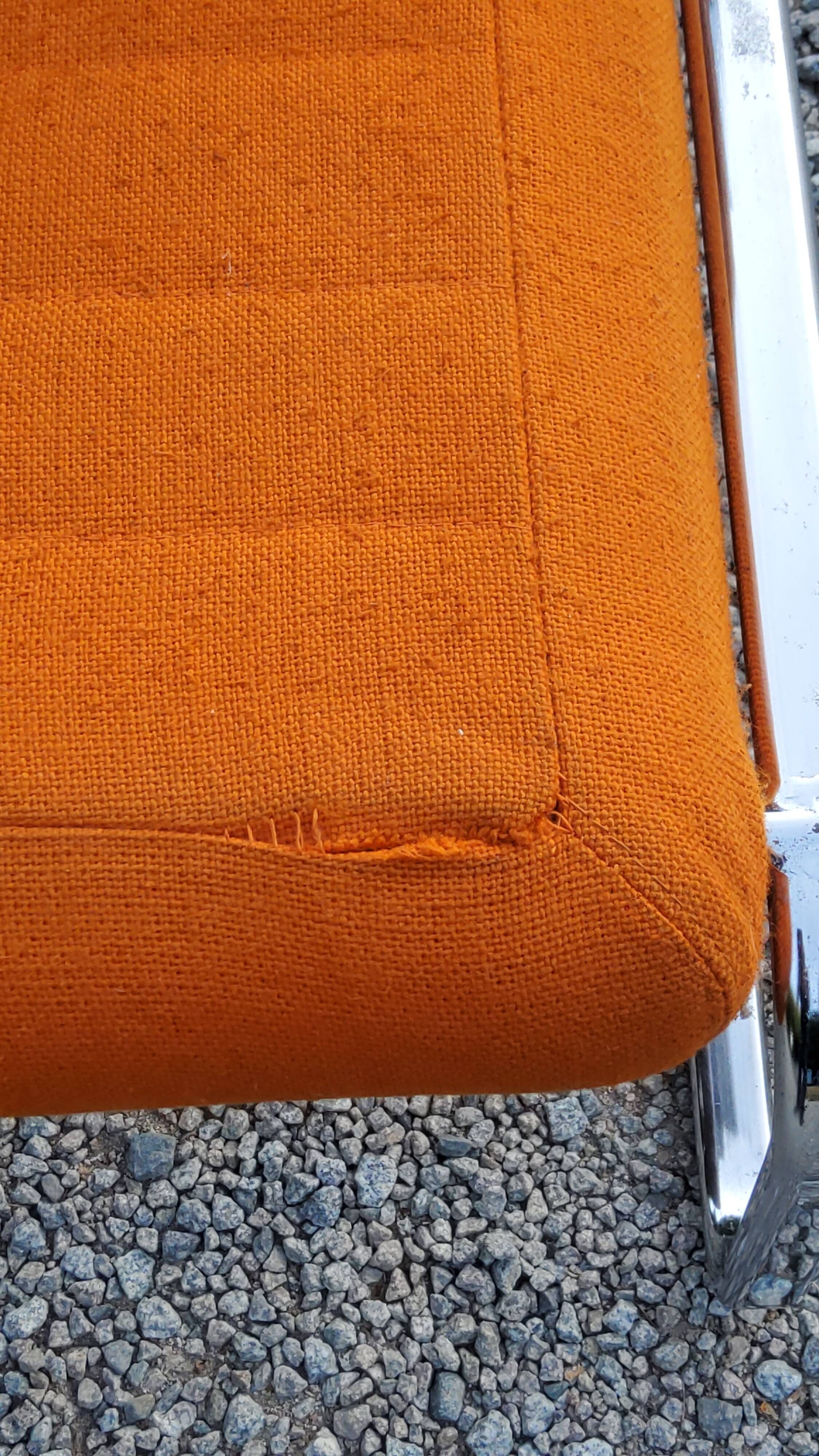 Pair of designer armchairs in orange fabrics and chrome tubes from the 70s