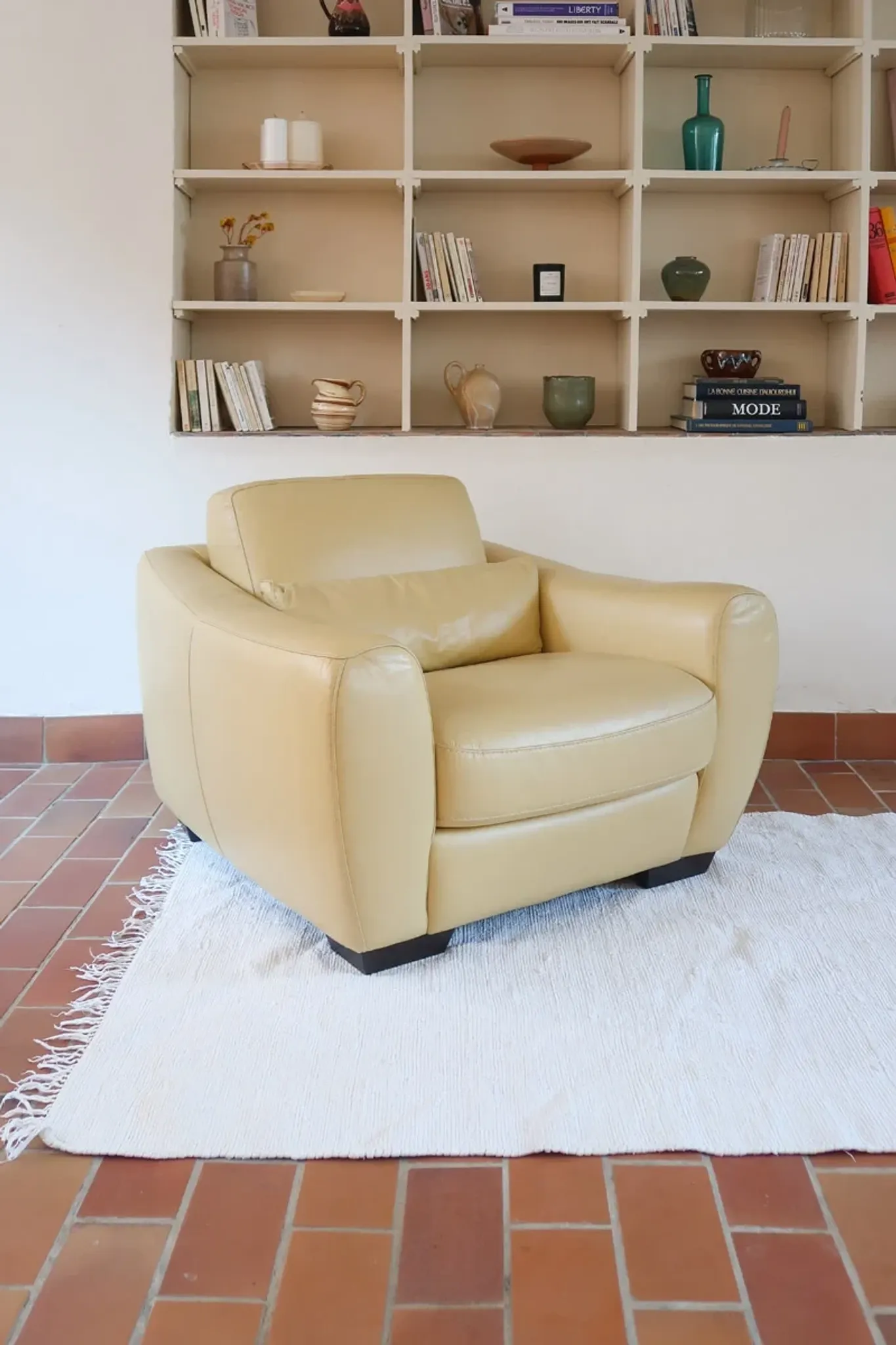 Vintage club armchair in butter yellow faux leather from the 1980s.
