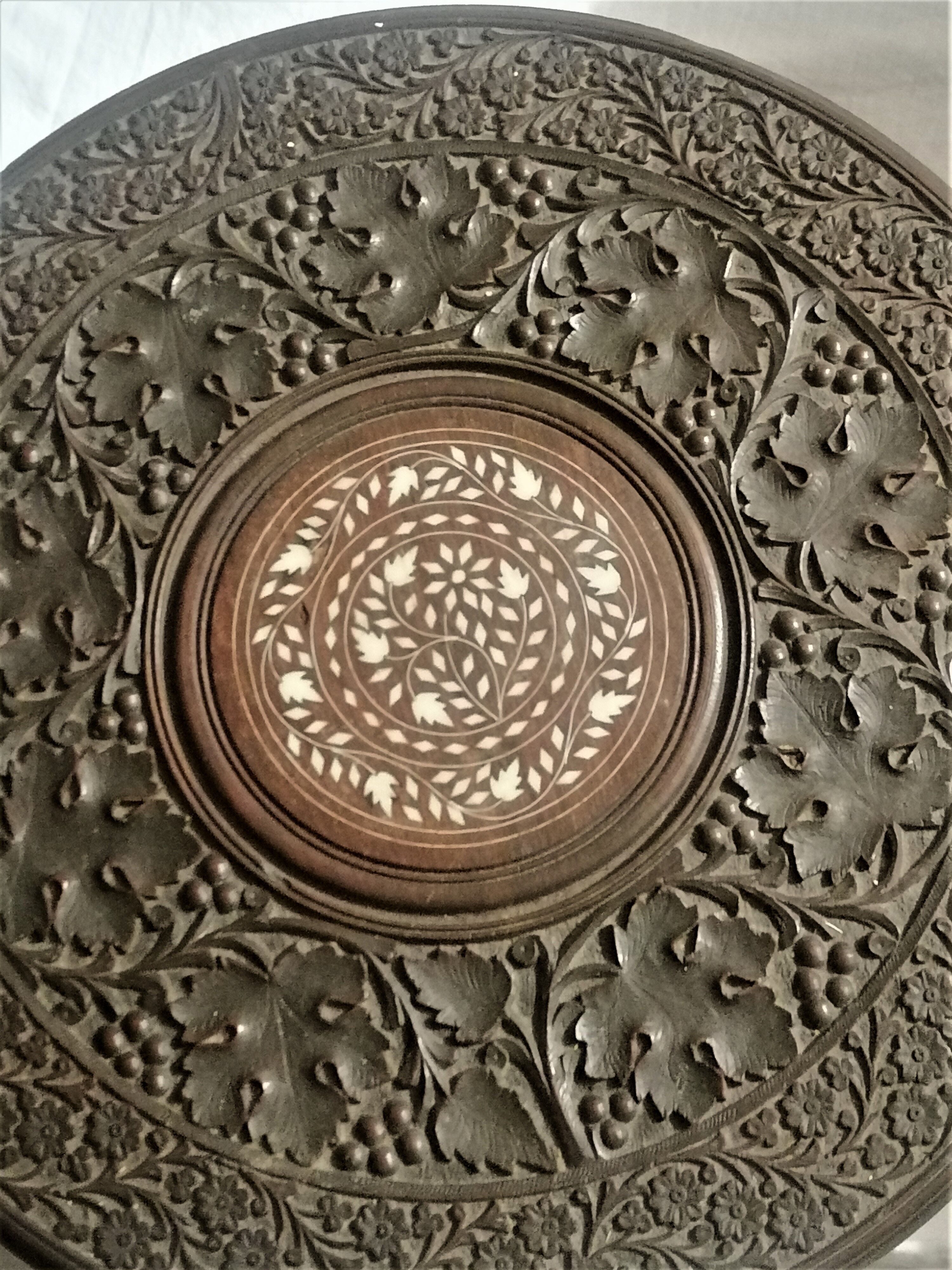 Ancient oriental pedestal table in carved wood