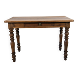 Antique writing table in the Napoleon III style with turned wooden legs.
