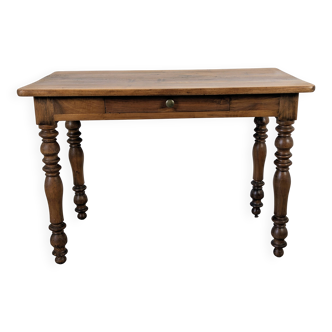 Antique writing table in the Napoleon III style with turned wooden legs.