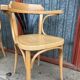 Pair of curved wooden bistro chairs with armrests