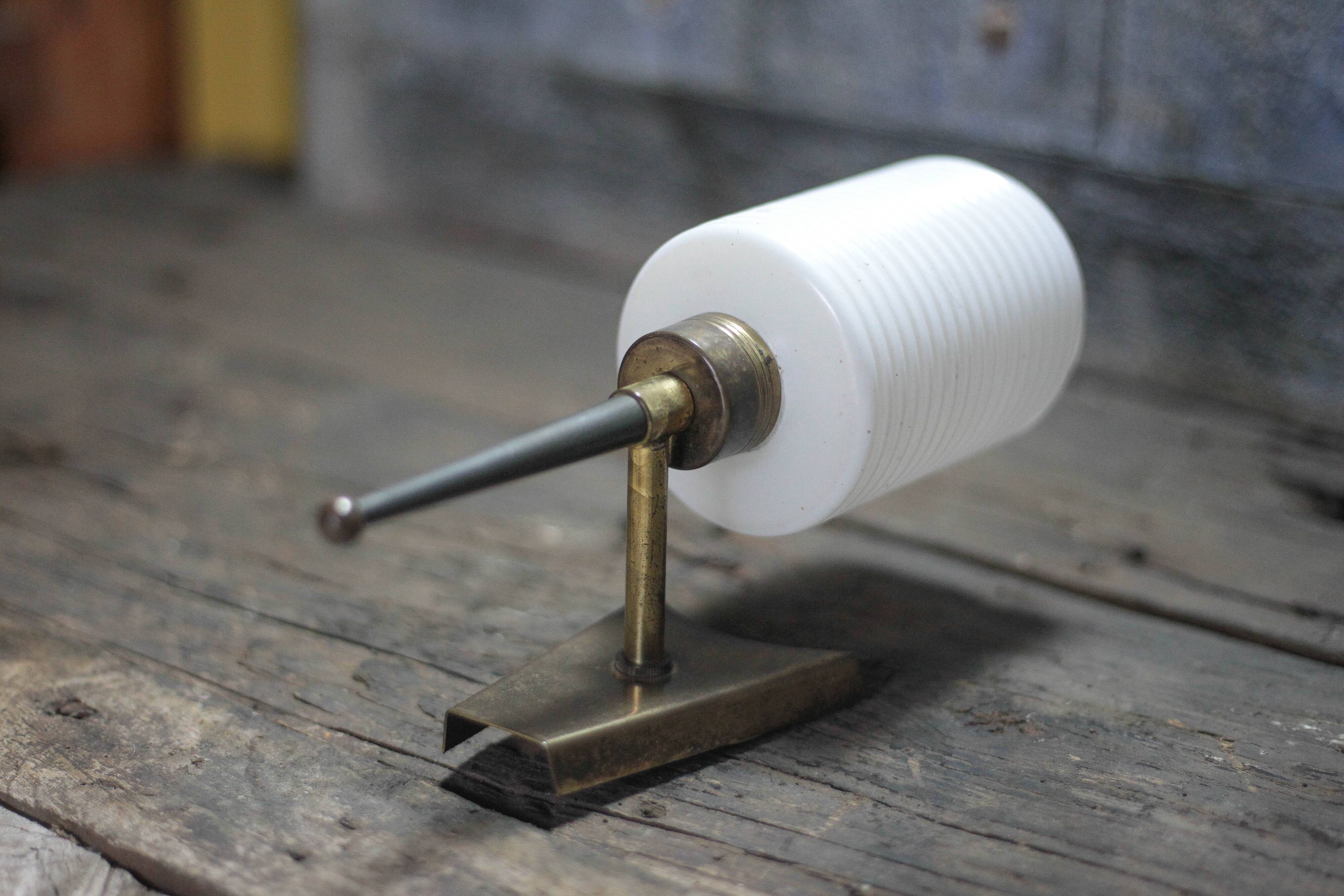 Brass wall light, black lacquered metal and white opal glass, 50s.
