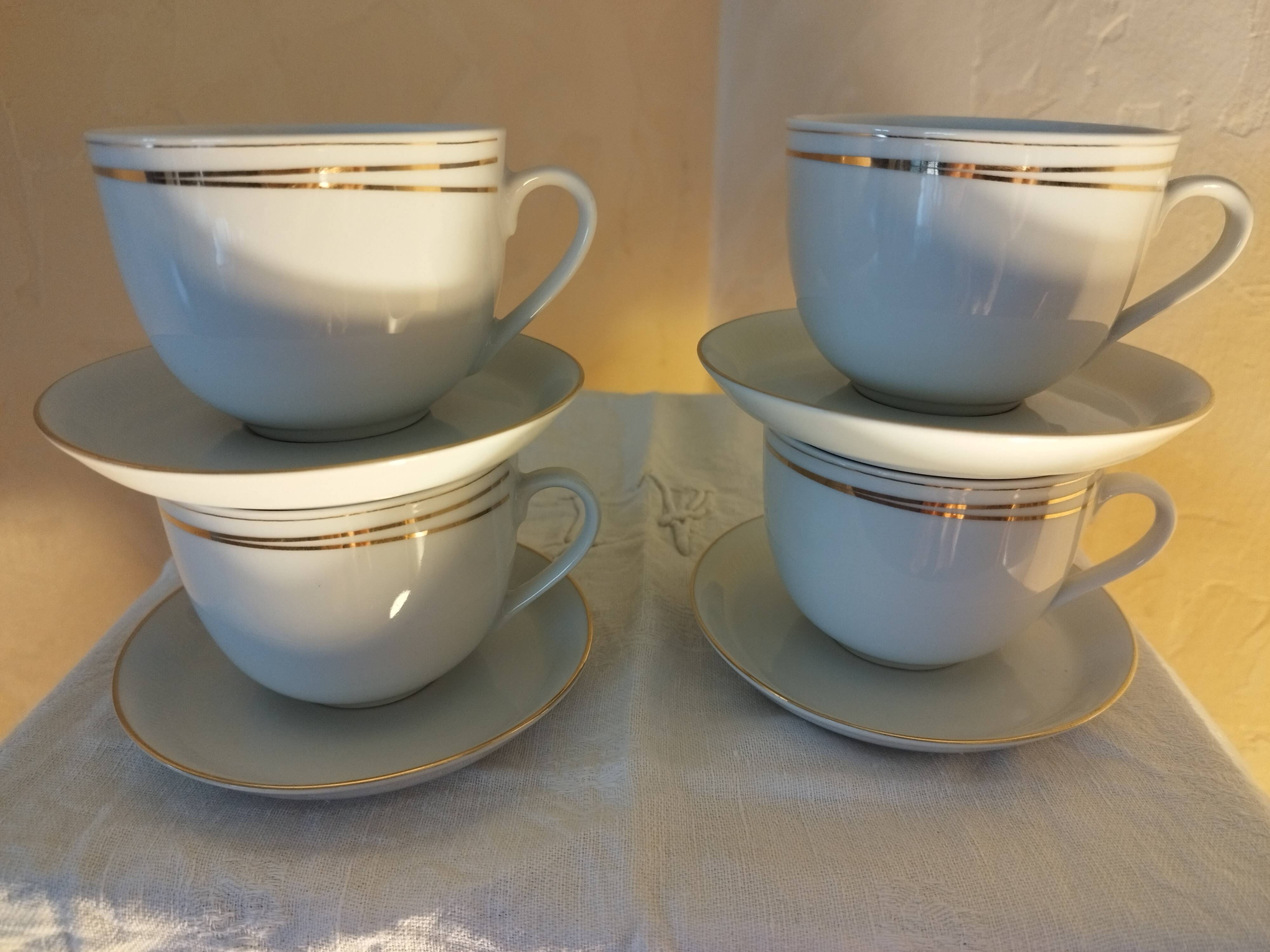 Set of 4 white and gold porcelain cups