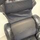 Vintage black leather lounge chair — low postmodern club chair from the space age.
