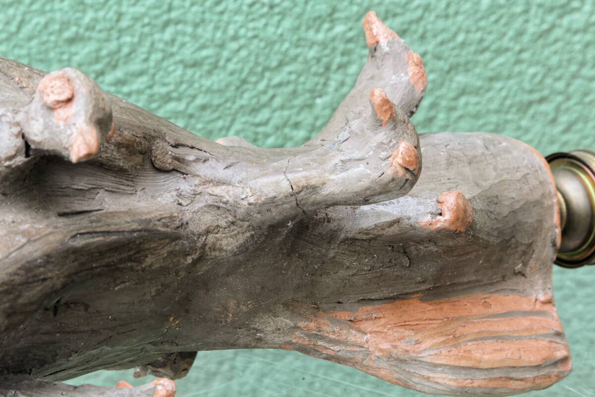 Lamp base in sculpted terracotta featuring birds, signed.