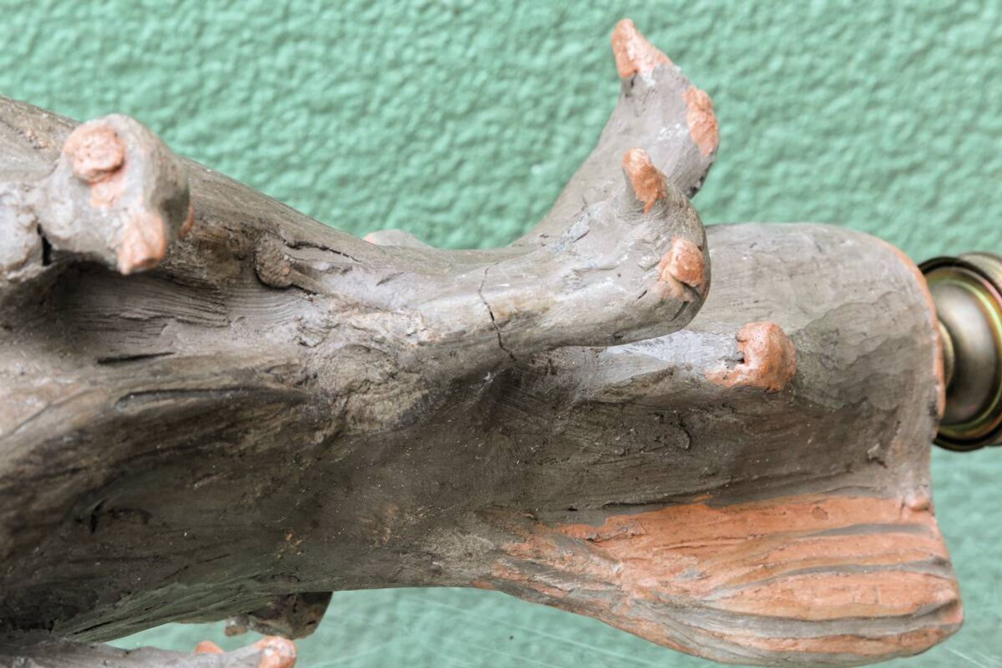 Lamp base in sculpted terracotta featuring birds, signed.