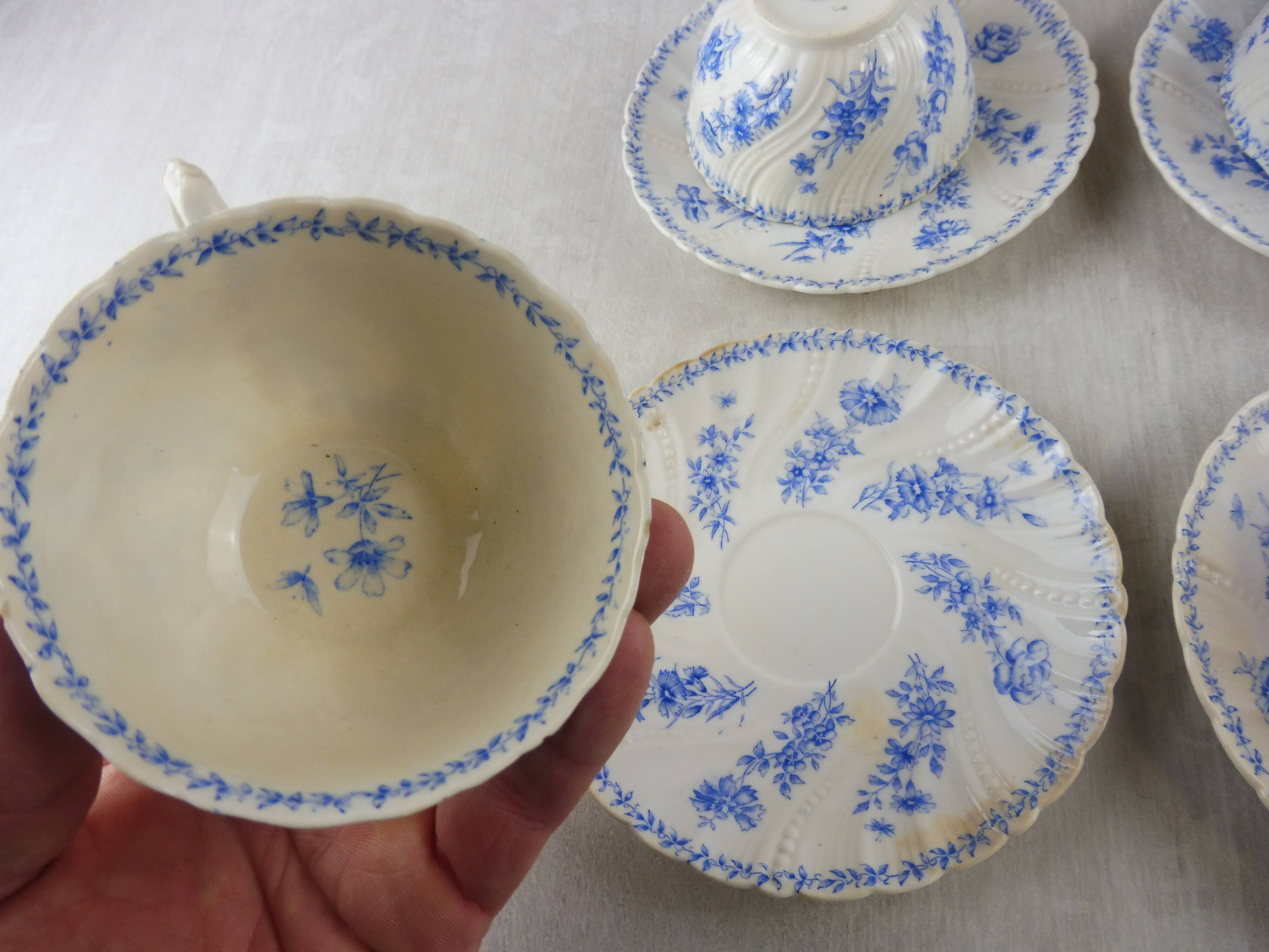 Lot of porcelain cups and under cups, twisted decoration, from Sarreguemines