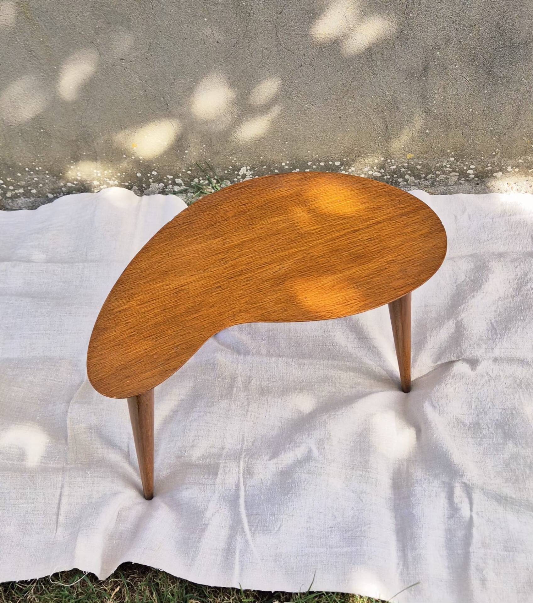 Vintage Scandinavian bean side table with wooden tapered legs.