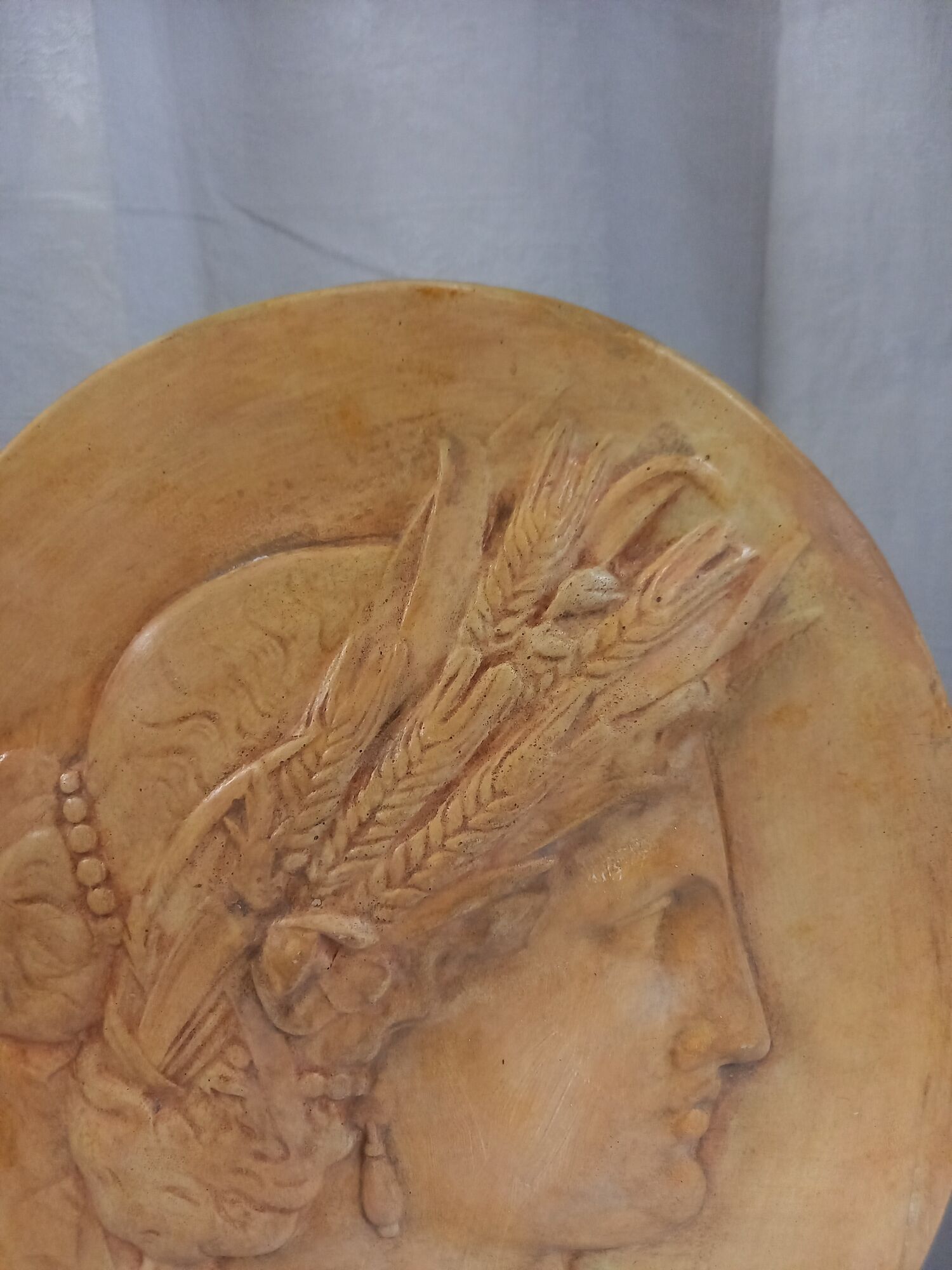 Plaster medallion, high relief, yellow ochre patina, representing the Roman divinity Ceres