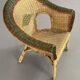 Cabriolet style armchair in rattan, wicker and green and red edging