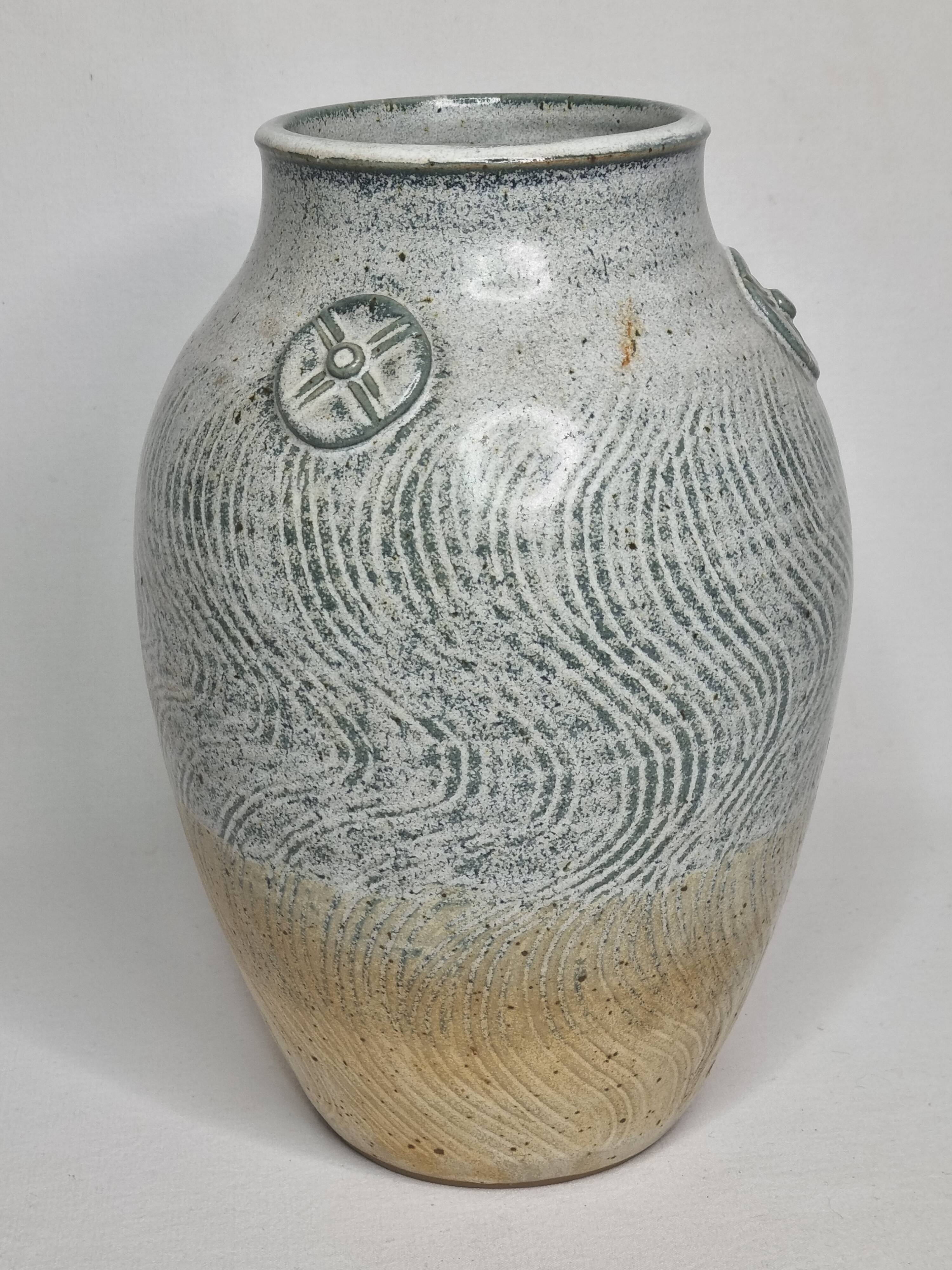 Stoneware vase signed by Sylvie Dufour, incised decoration and relief medallions, 28 cm.