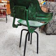 Vintage swivel workshop chair in green pressed sheet metal with a folding backrest.
