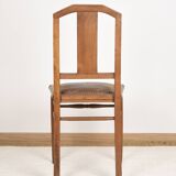 Art Deco style chair in carved wood and leather.