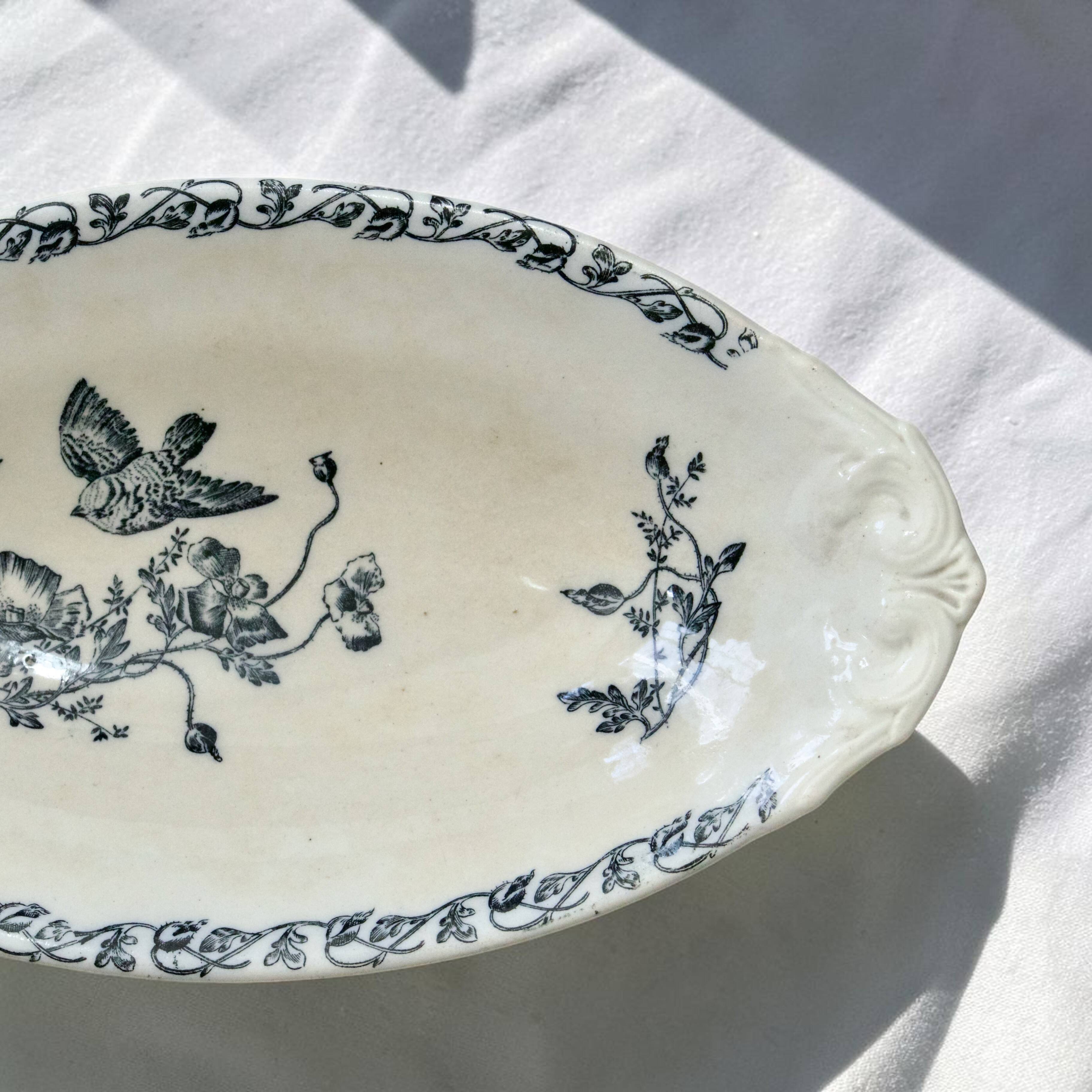 Iron flat plate with a 19th-century bird signed Onnaing "Poppies"