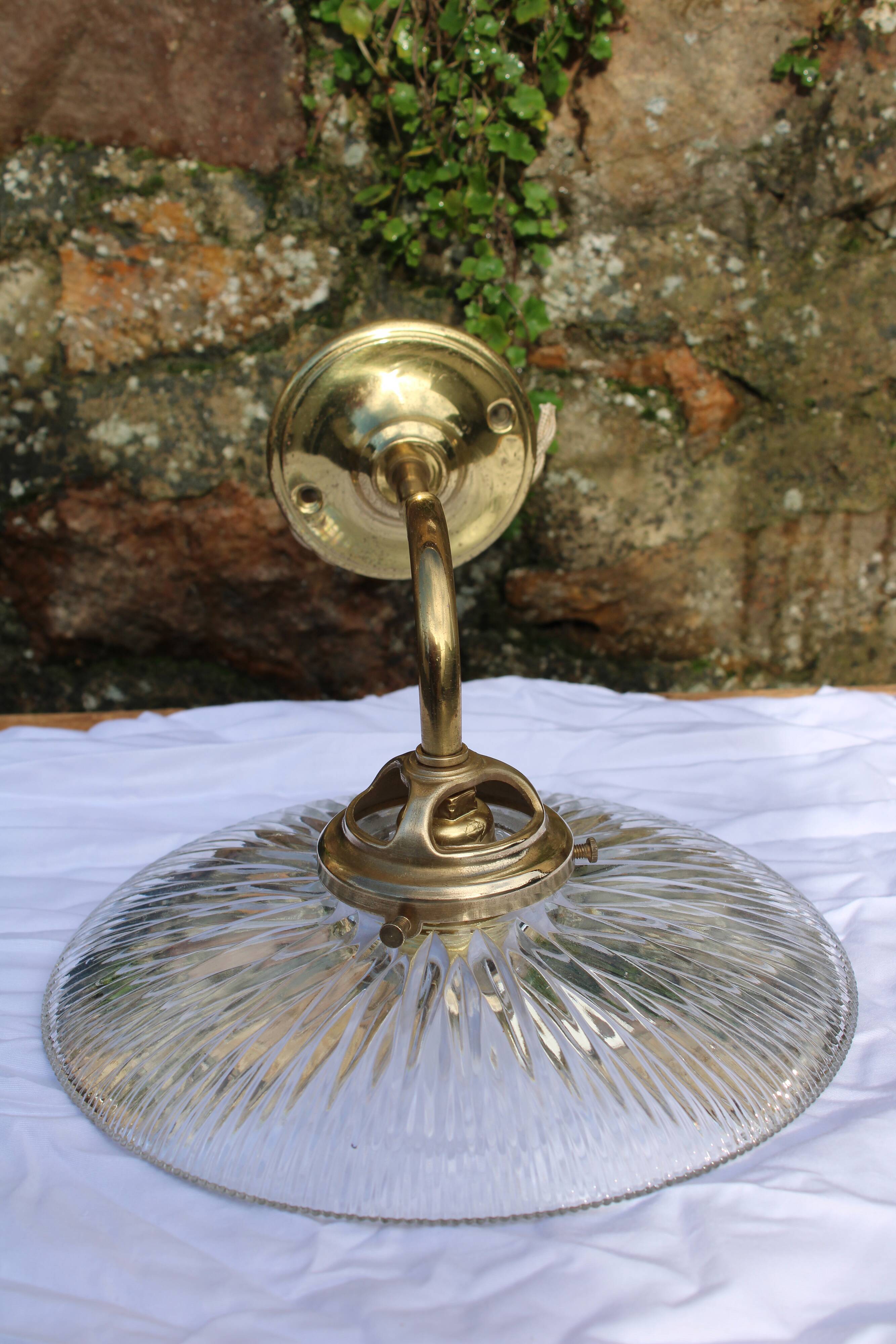 Holophane glass and brass wall light