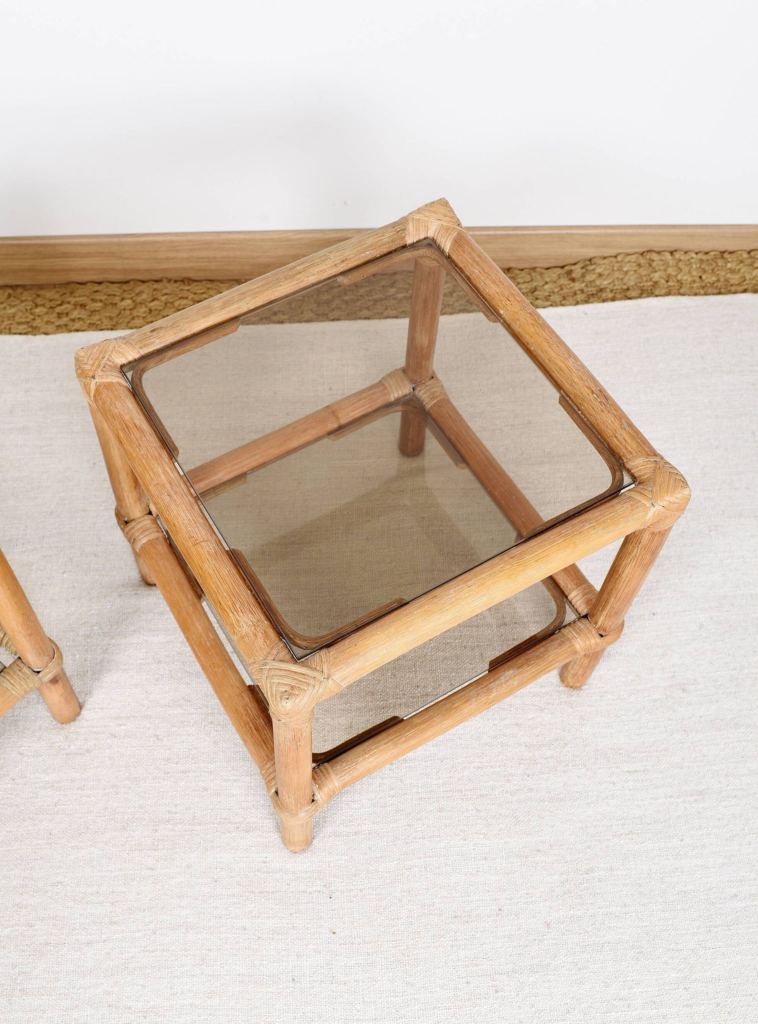 Pair of bedside tables or side tables, in rattan and smoked glass