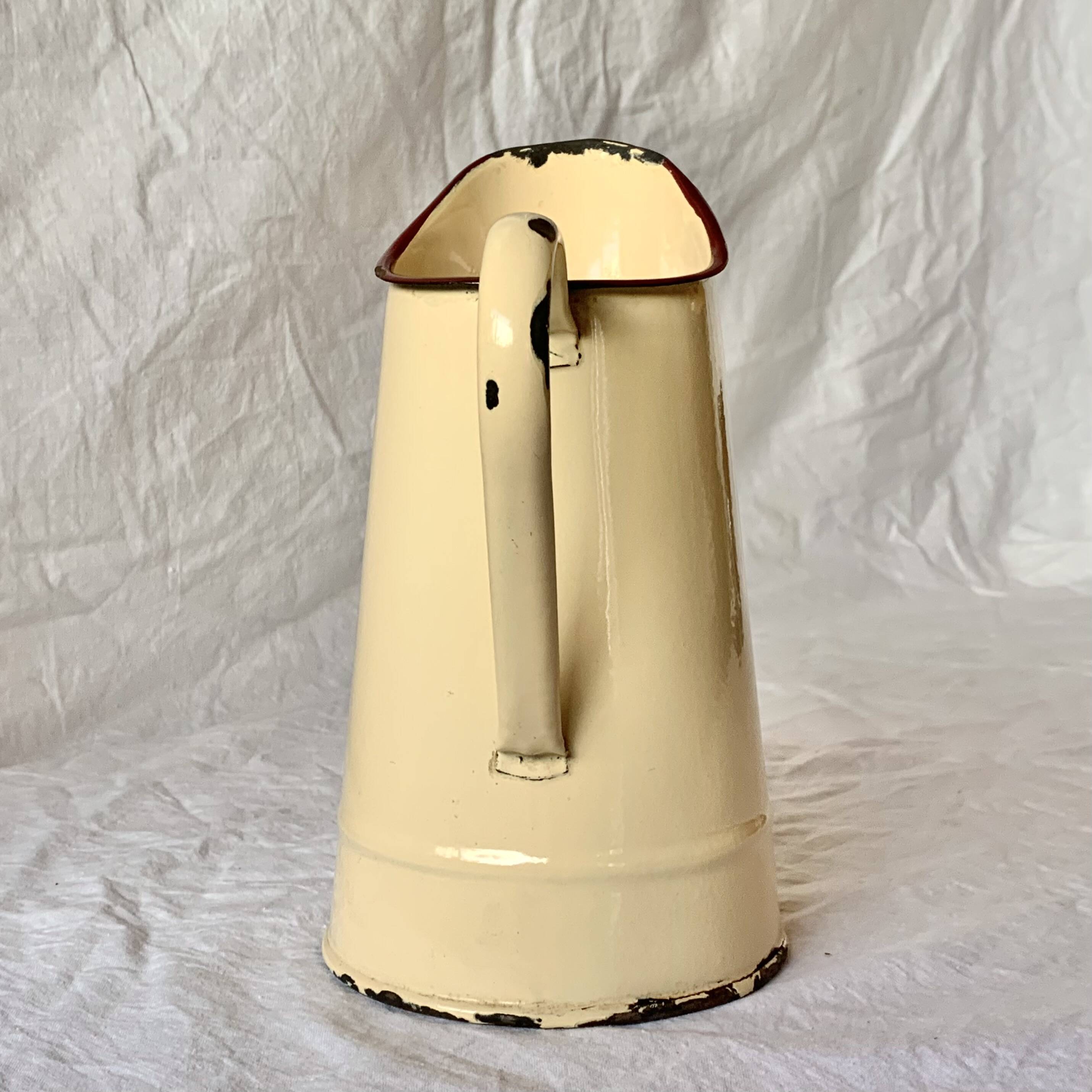 Vintage pitcher or jug in beige enamelled sheet metal