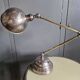 Old adjustable industrial lamp in bronze with 2 arms.