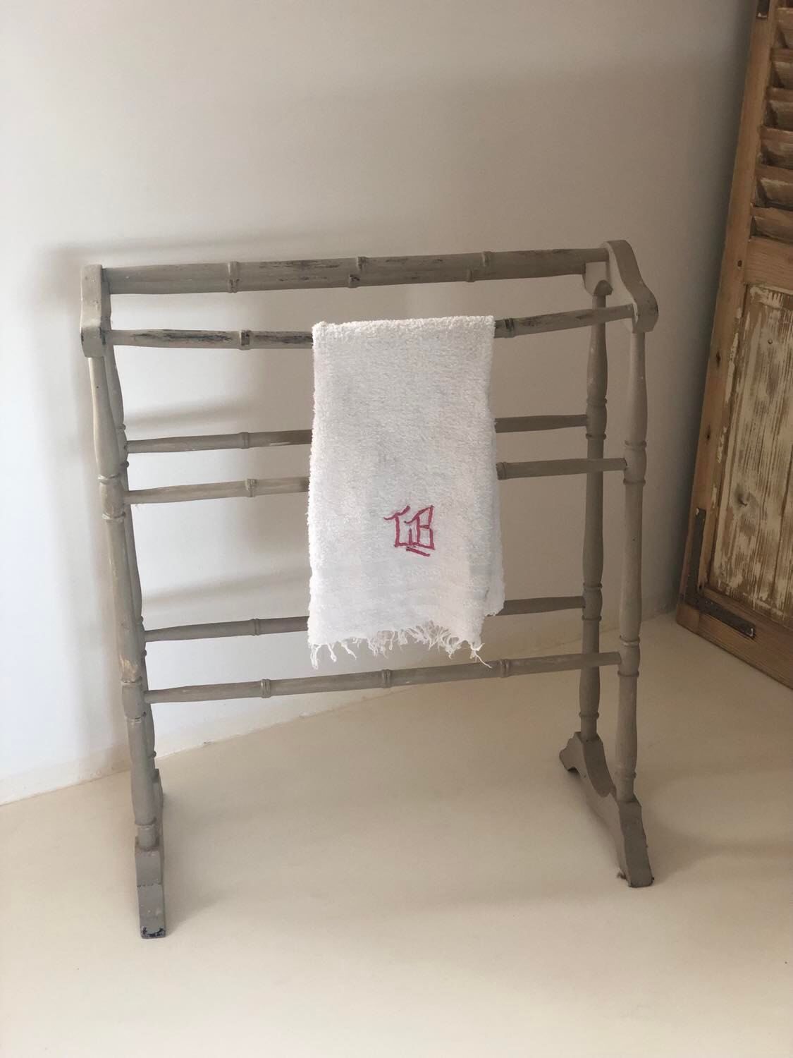 Old bathroom towel rack in patinated wood