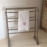 Old bathroom towel rack in patinated wood