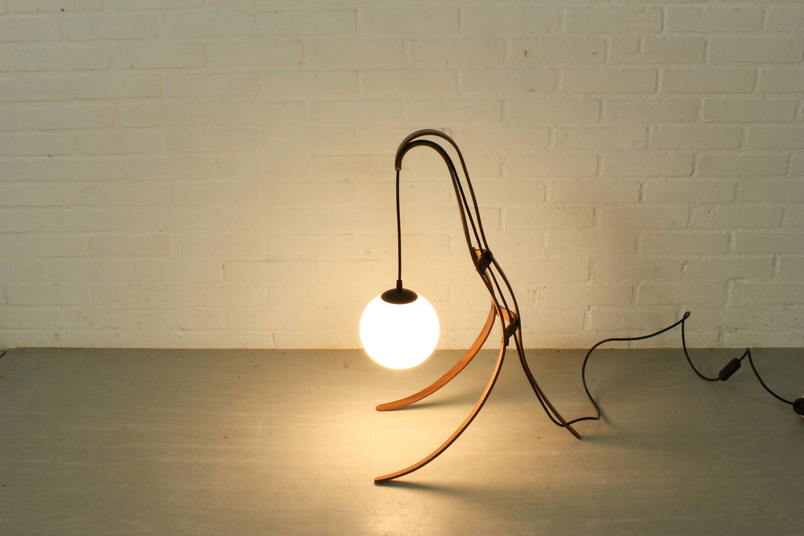 Sculptural table lamp with globe