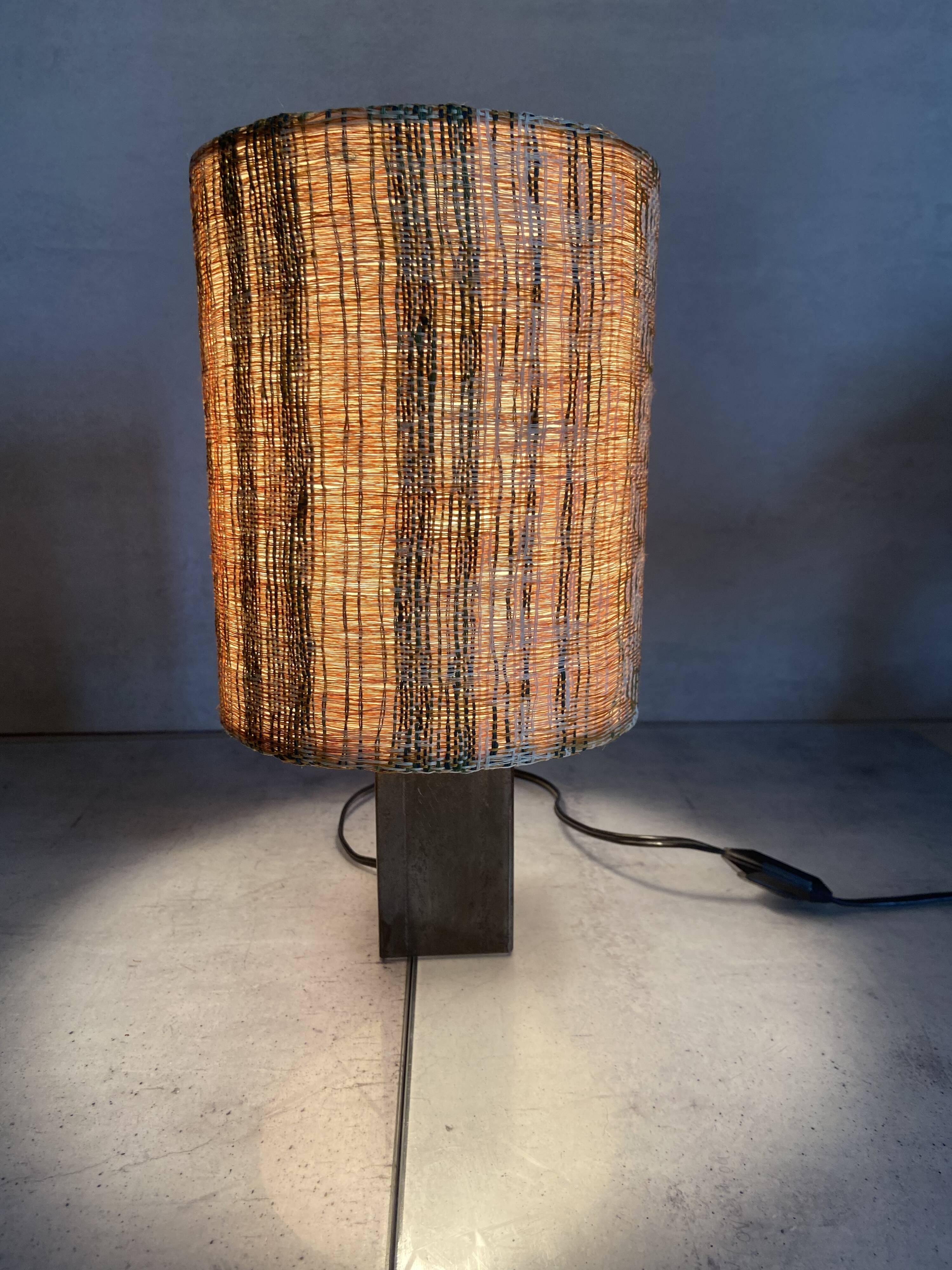 Small modernist table lamp with hand-woven shade.