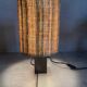 Small modernist table lamp with hand-woven shade.