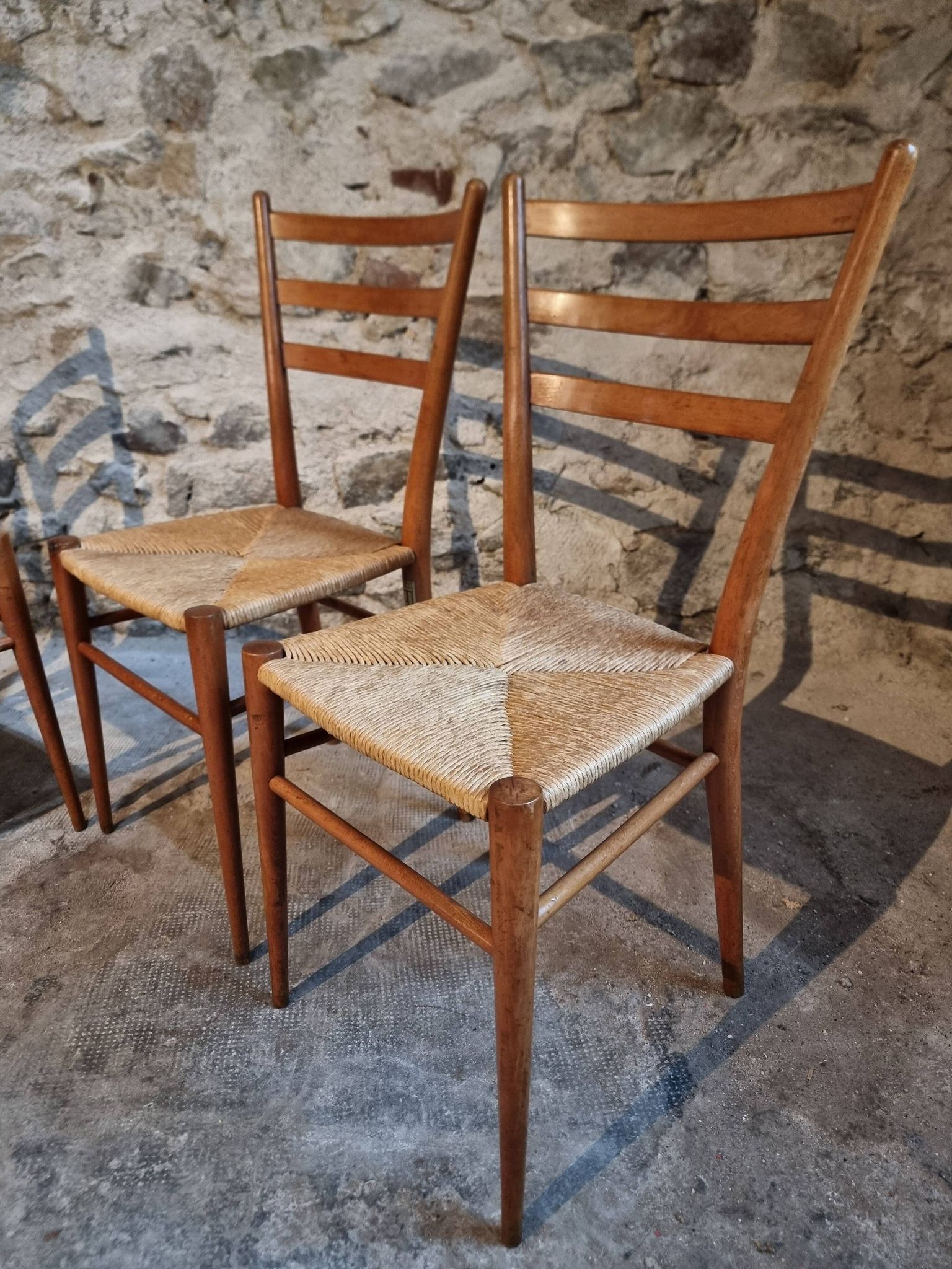 Set of 4 mid-century Italian dining chairs with woven seats, circa 1950–1970.
