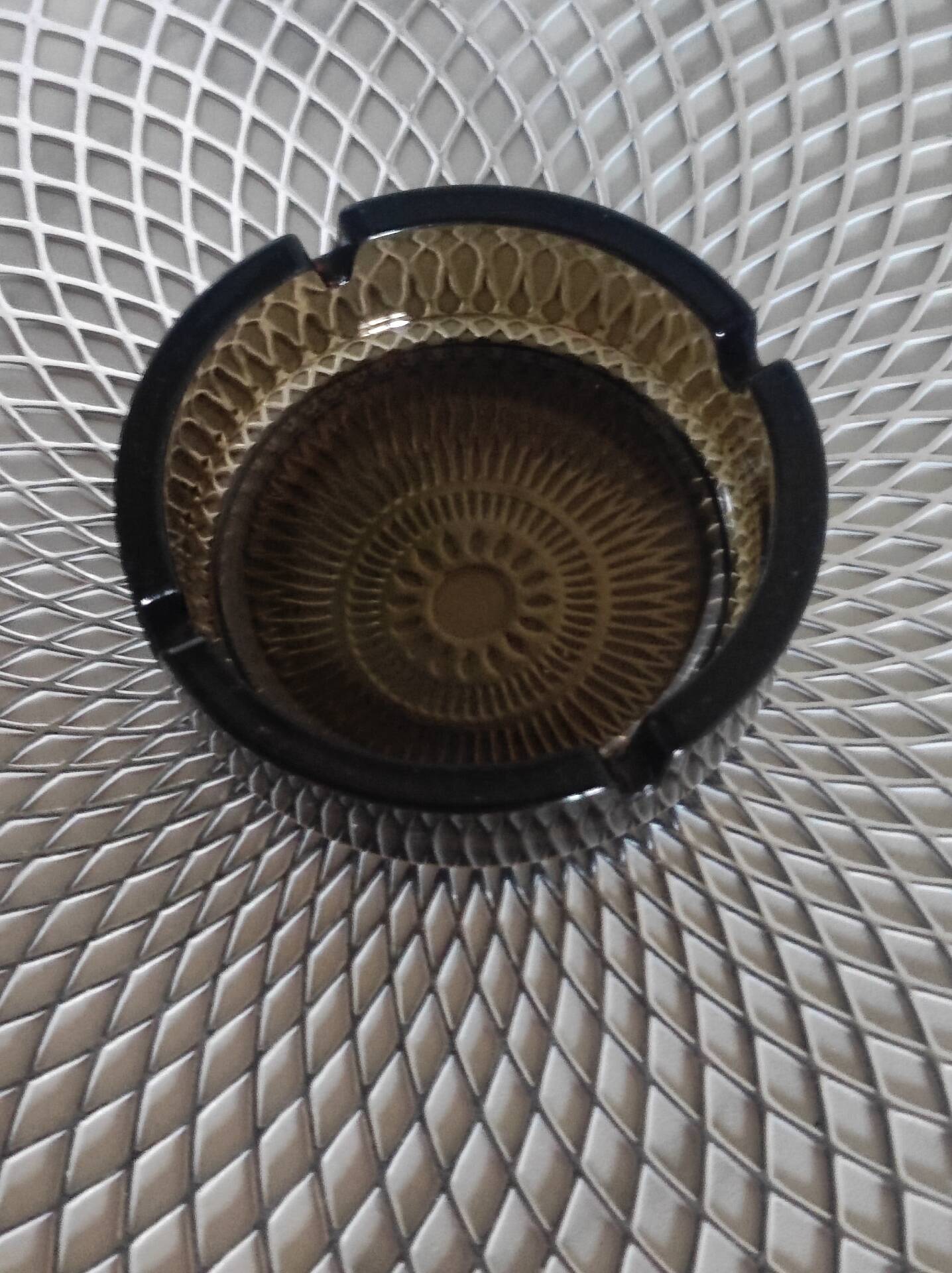 Dark smoked glass ashtray from the 1970s.