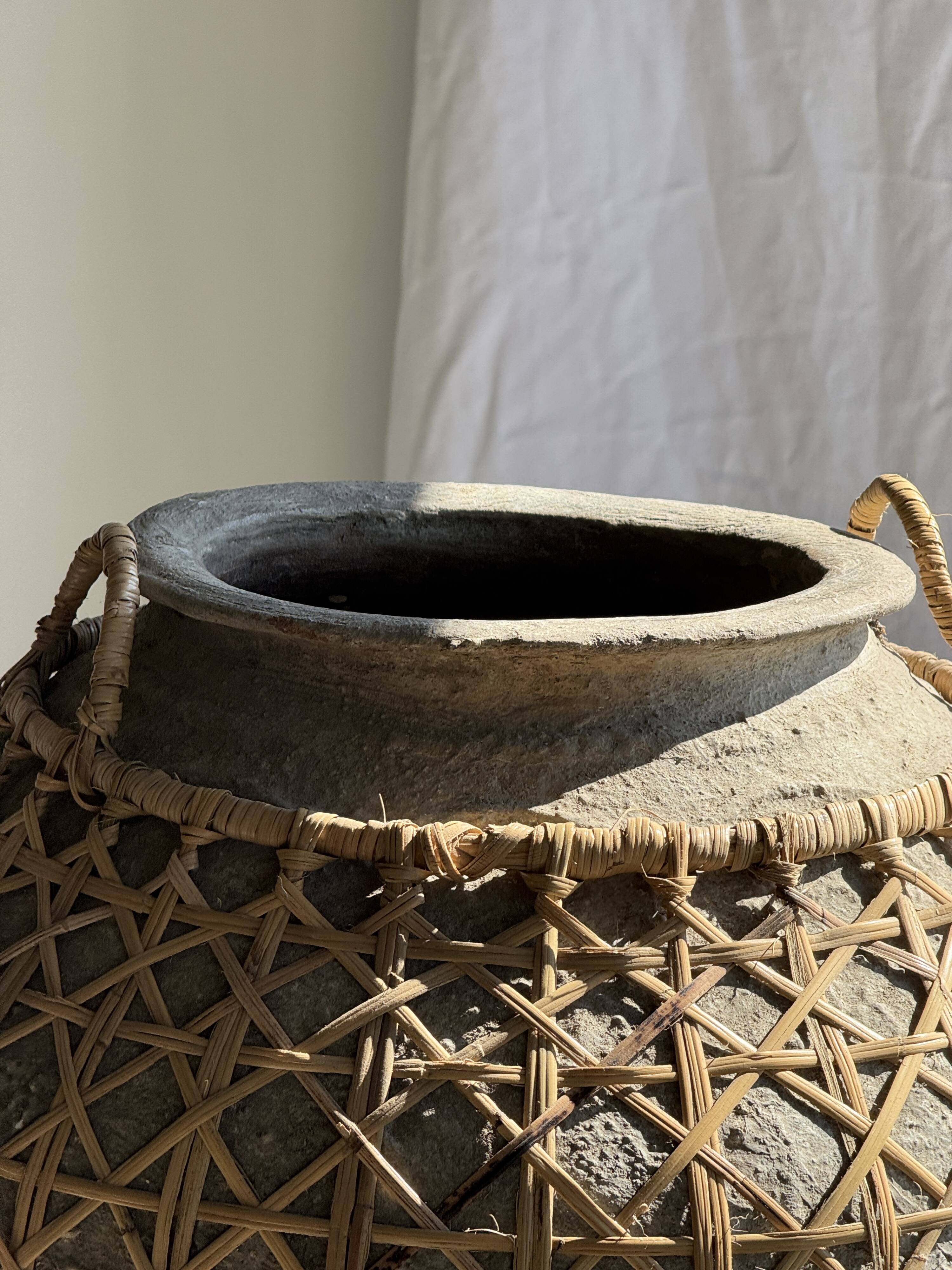 Immense light grey antique-style pot with a crosshatch lid and handles.