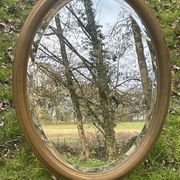 Bevelled golden oval mirror, 79 x 59 cm