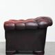 Classic cowhide chesterfield buttonseat armchair in a beautiful red colour and elegant round shapes