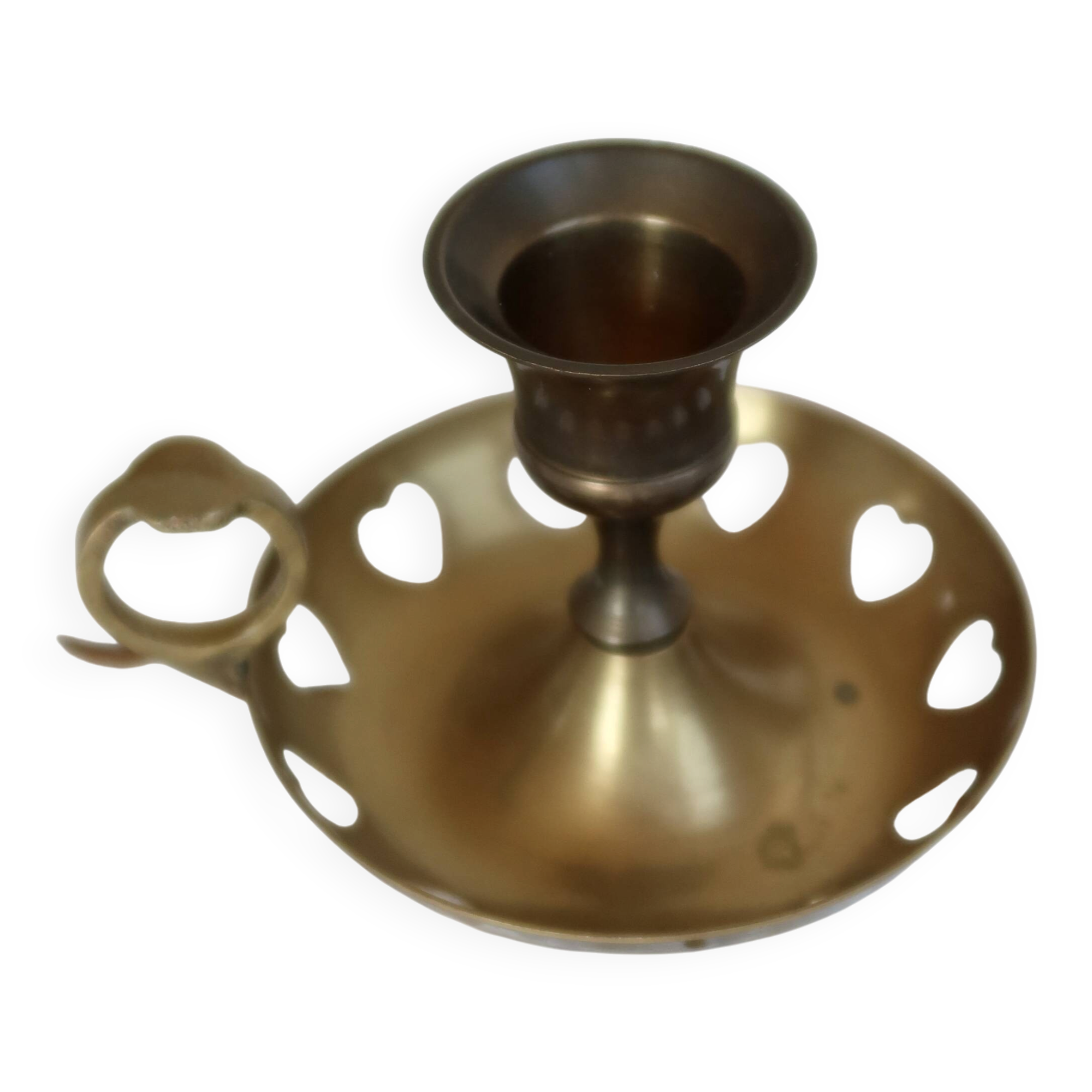 Antique brass rat trap with heart patterns.