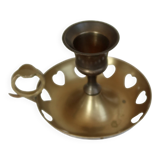 Antique brass rat trap with heart patterns.