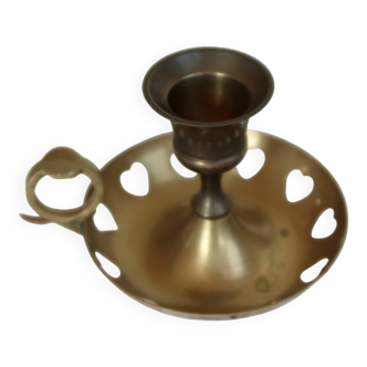 Antique brass rat trap with heart patterns.