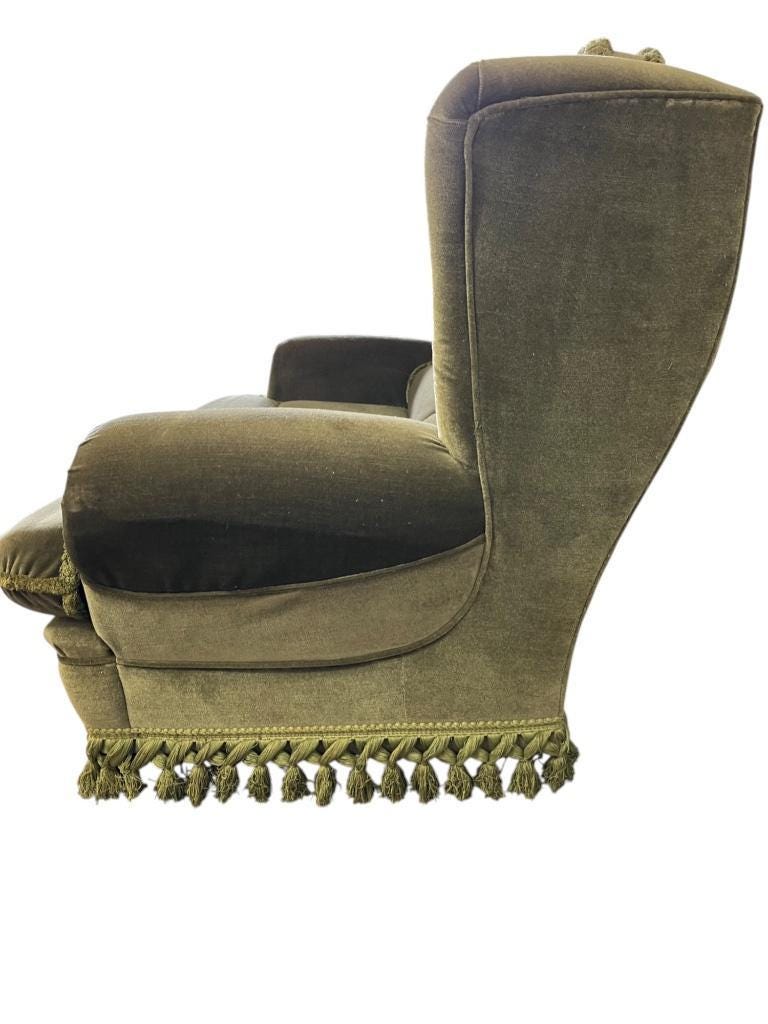 Vintage green two-seater sofa with fringes