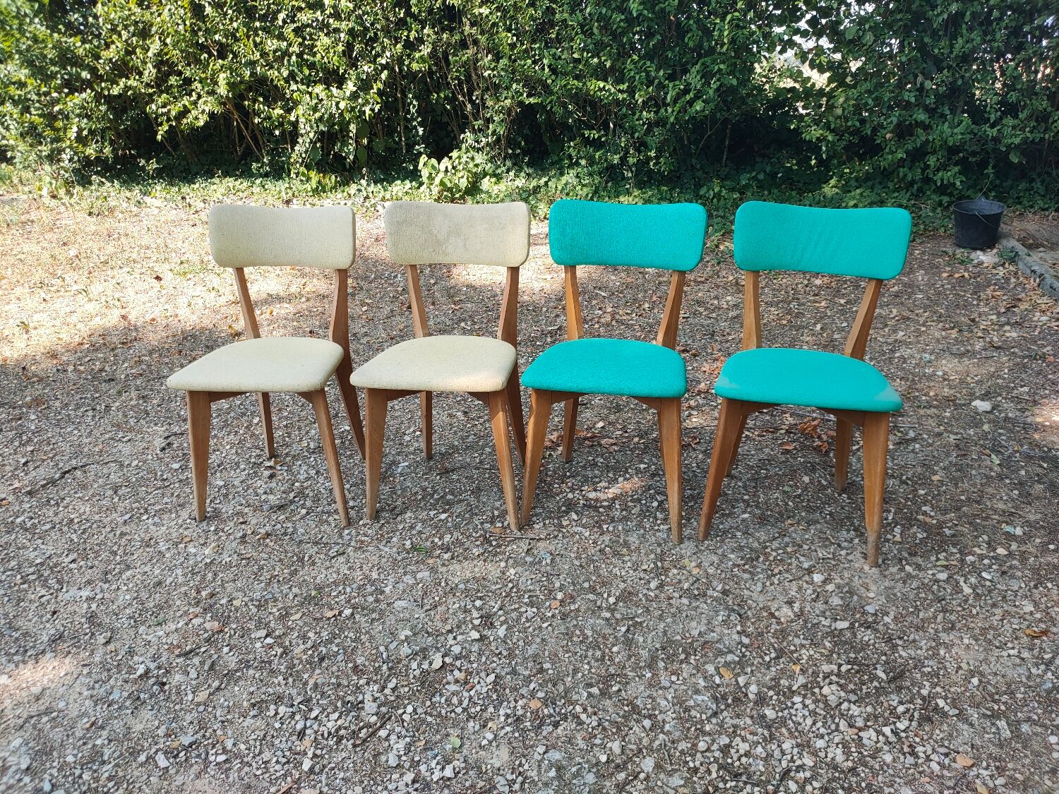 Set of 4 vintage chairs in wood and imitation blue leather dating from the 50s. Wooden structure. Seat and backrest in imitation leather 2 mint green and 2 yellow. Seating dimension: 46 cm. Good state of conservation, some traces of wear.