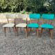 Set of 4 vintage chairs in wood and imitation blue leather dating from the 50s. Wooden structure. Seat and backrest in imitation leather 2 mint green and 2 yellow. Seating dimension: 46 cm. Good state of conservation, some traces of wear.