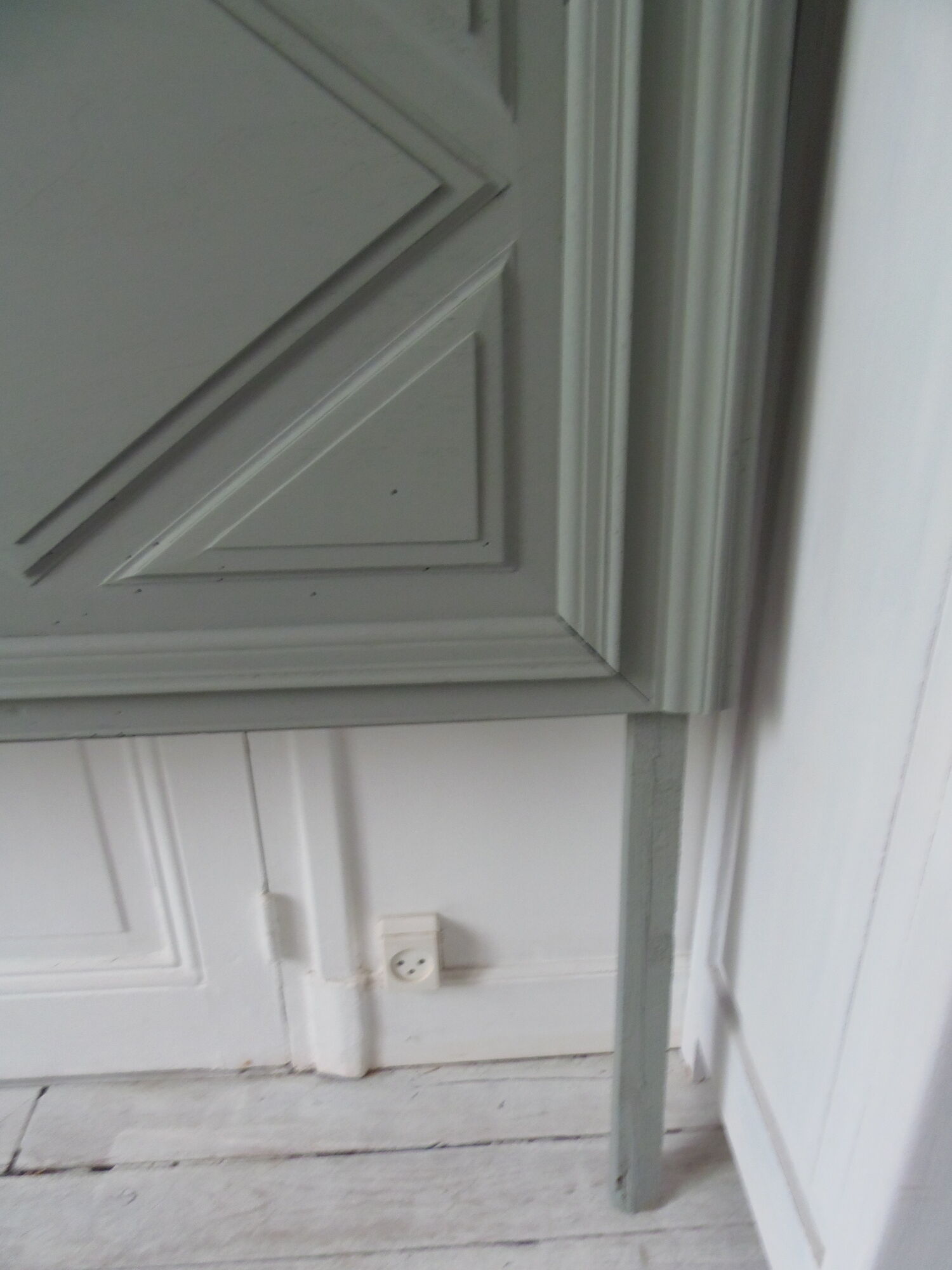 Headboard made with an old walnut door, re-enchanted in gray green waxed finish,