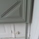 Headboard made with an old walnut door, re-enchanted in gray green waxed finish,