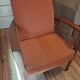 Vintage Art Deco armchair in curved wood and terracotta fabric.