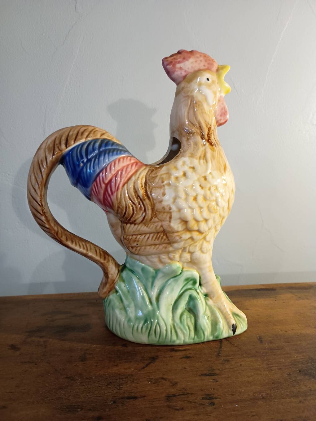 Vintage slipware jug in the shape of a rooster.