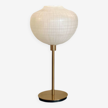 Table lamp with a white striped glass globe lampshade and a gold base