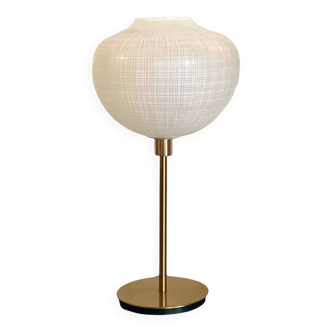 Table lamp with a white striped glass globe lampshade and a gold base