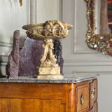 Alabaster bowl decorated with vine leaves on a base of three dolphins, circa 1880.