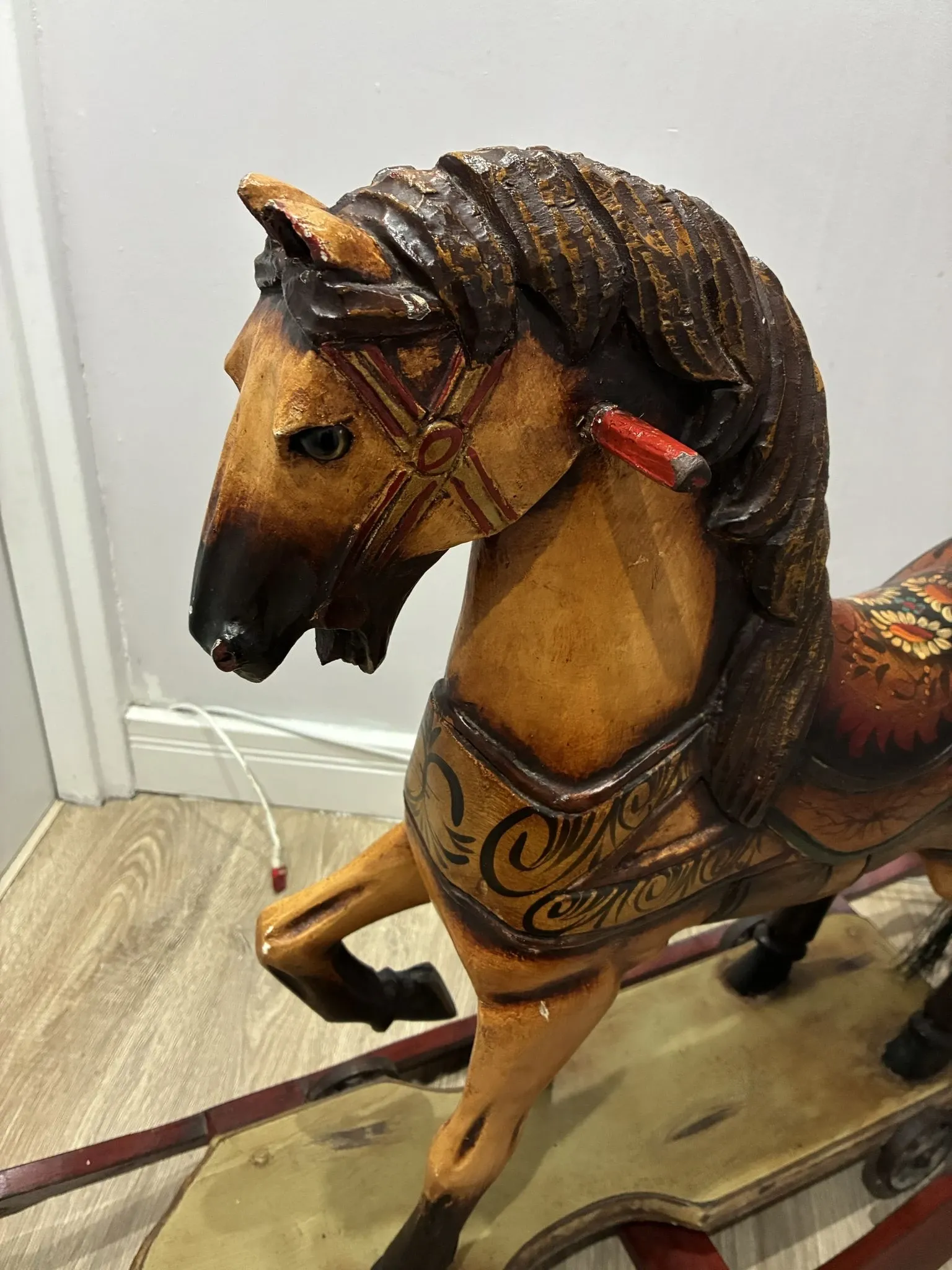 Antique hand-carved rocking horse on wheels, early 20th century