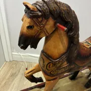 Antique hand-carved rocking horse on wheels, early 20th century